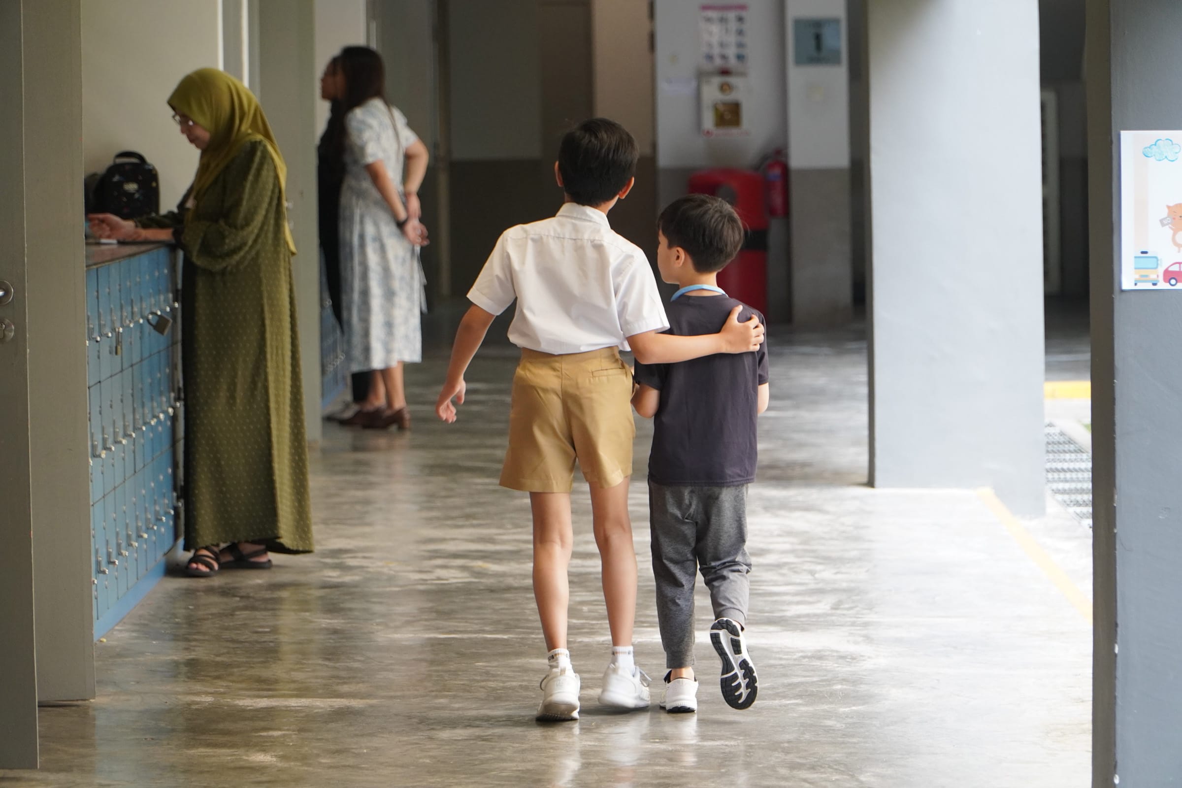 Student Prefect guide new p1 student back to class. 
